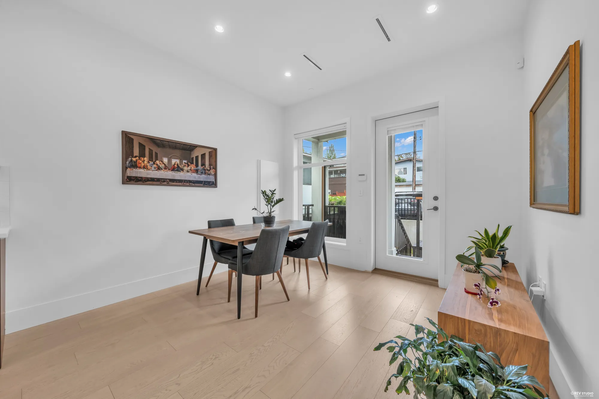 The dining table and a sideboard, the door to the deck on the right