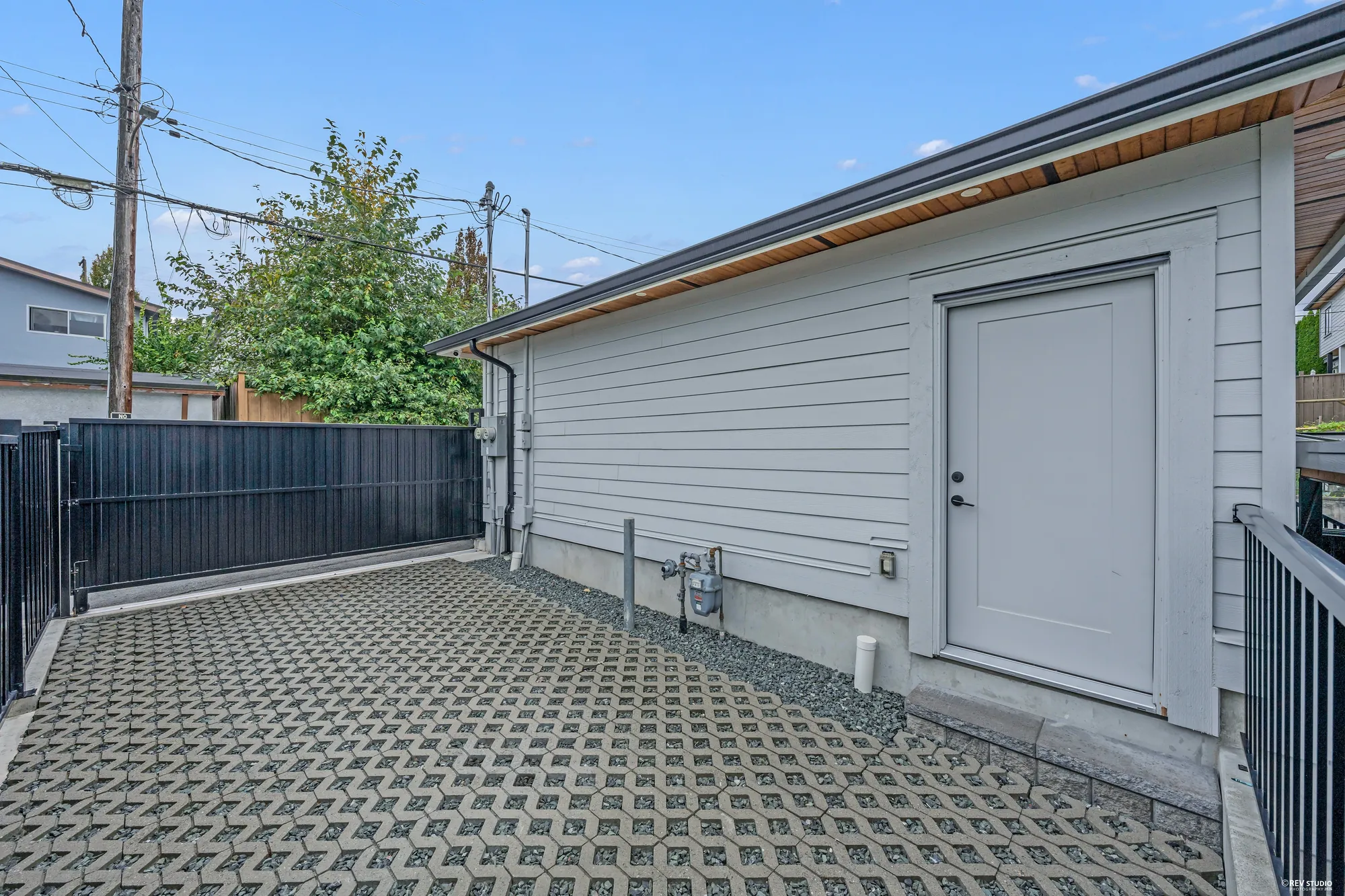 The side door of the garage and the permeable paving, from the yard side