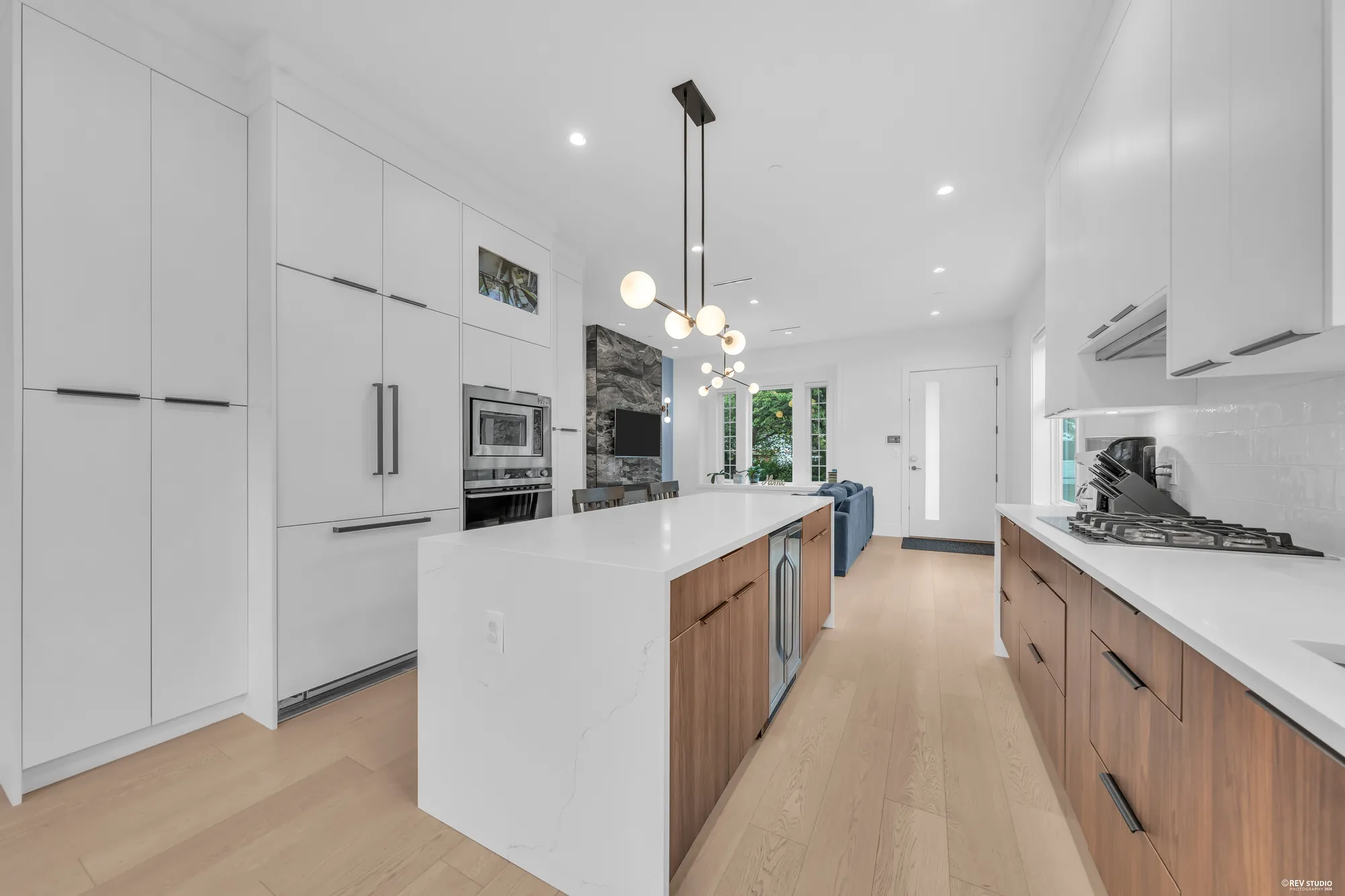 The kitchen from the dining end, the island and the tall cabinets