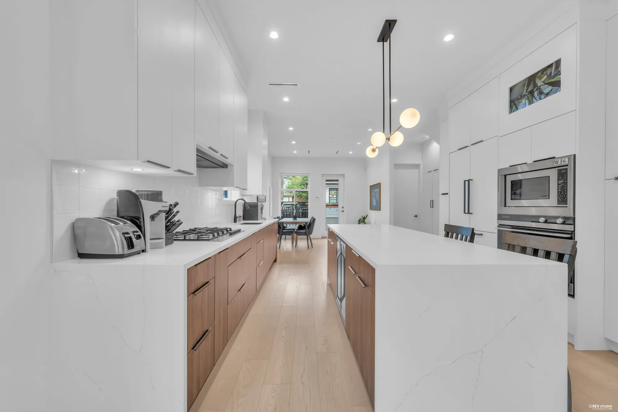 The kitchen from the living room side, the wall ovens in the tall run on the right