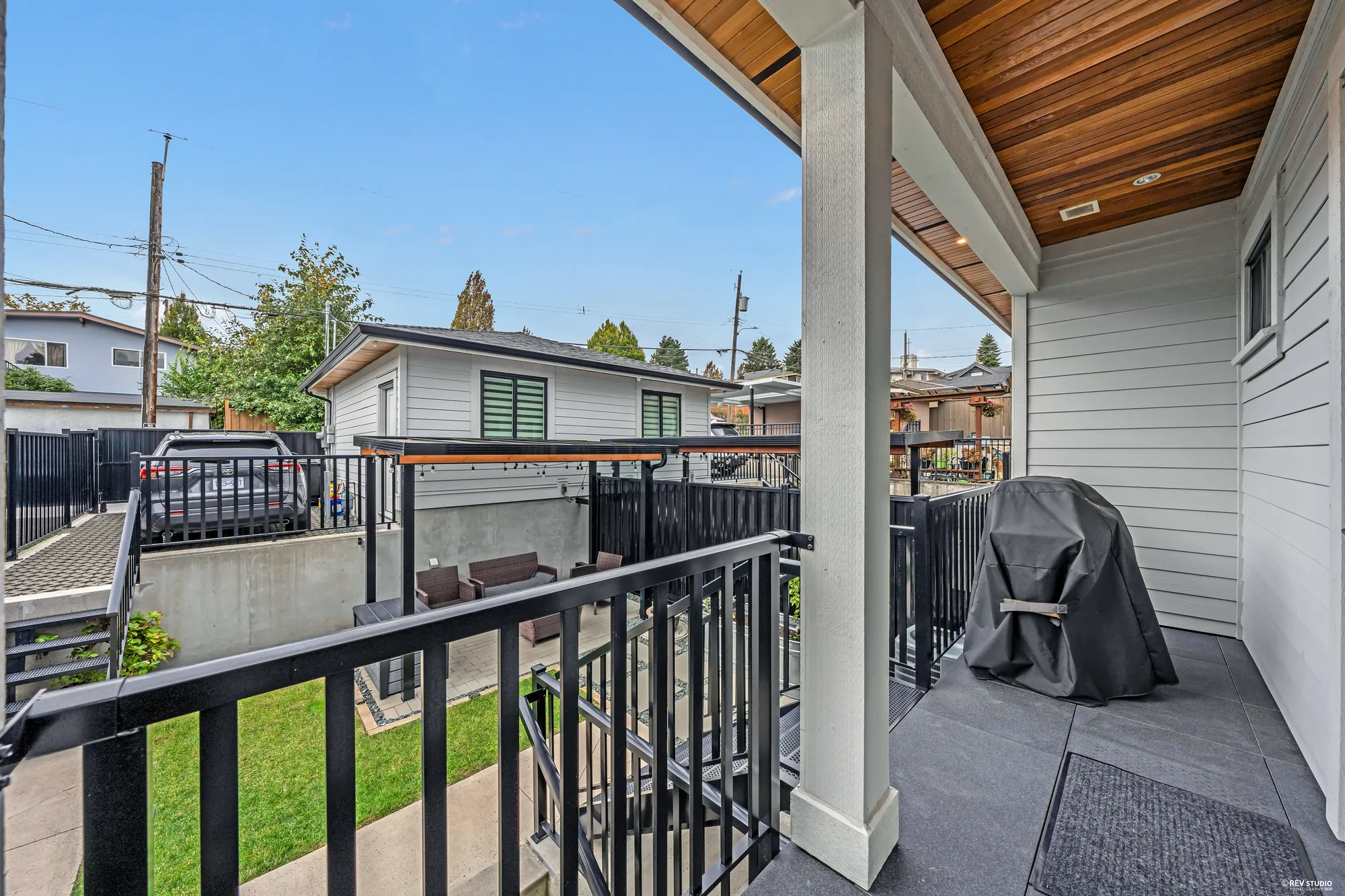 From the deck off the dining room, looking over the patio and the yard to the garage and the lane